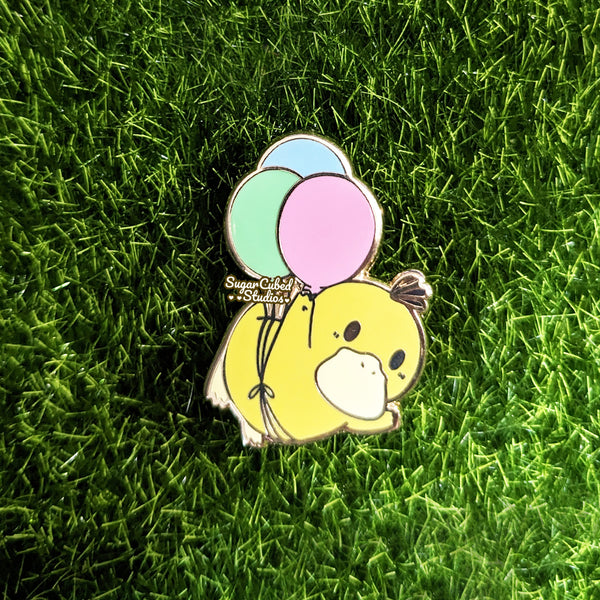 yellow duck with blue, pink, green balloon enamel pin.