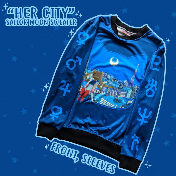 a cute blue polyster sweater with sailor moon sitting on a silhouette cat looking out towards Tokyo. The sleeves are printed with the symbols of the sailor scouts.